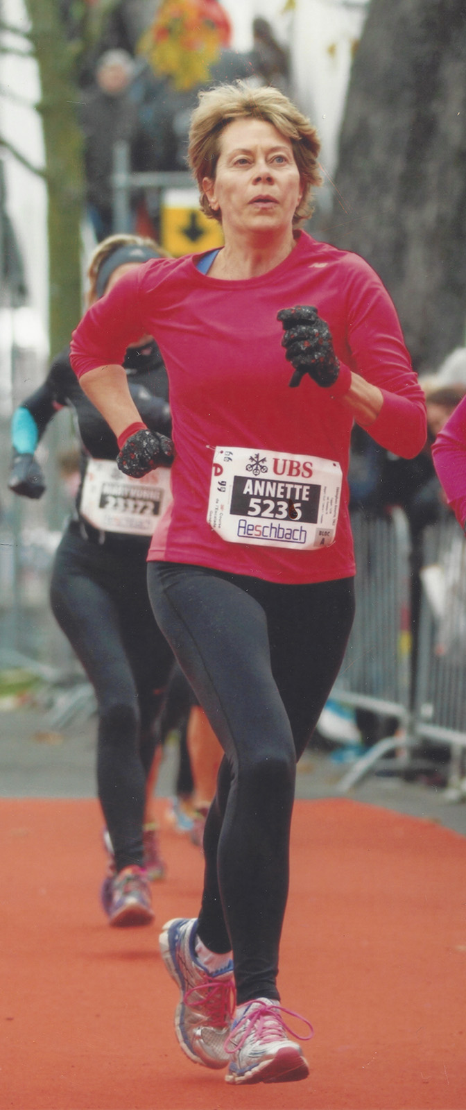Annette-running-marathon woman-running-marathon-start-number-on-red-shirt
