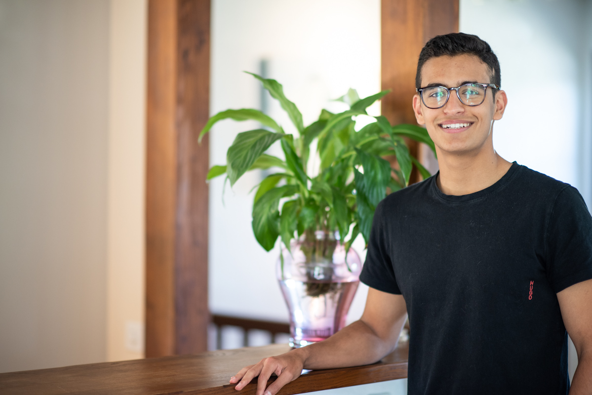 young-man-in-glasses-black-tshirt-standing-headshot